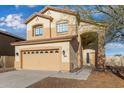 Exterior shot showcasing the two-story home with desert landscaping, front door and attached garage at 2834 N Paisley Ln, Casa Grande, AZ 85122