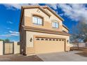 Angled view of a two-story home showing garage, side gate, and desert landscaping against a blue sky at 2834 N Paisley Ln, Casa Grande, AZ 85122