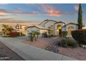 Beautiful home with manicured front yard, desert landscaping, and a large driveway leading to a three-car garage at 3037 E Bighorn Ave, Phoenix, AZ 85048