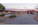 Desert home features detached garage, desert landscaping, private courtyard, and circular driveway at 36801 N Long Rifle Rd, Carefree, AZ 85377