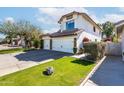 Beautiful home exterior featuring a well-maintained lawn and a spacious driveway leading to a garage at 3825 E Irwin Ave, Mesa, AZ 85206