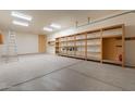 Spacious garage equipped with shelving and ample storage, perfect for organizing tools and equipment, plus a ladder at 39642 N Oxford Way, San Tan Valley, AZ 85140