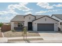 Charming single-story home with a well-manicured desert landscape and a two-car garage at 4022 S 178Th Ln, Goodyear, AZ 85338