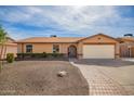 Traditional home featuring a two-car garage, low-maintenance landscaping, and a welcoming entranceway at 4133 W Wood Dr, Phoenix, AZ 85029