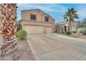 Inviting two-story home featuring a spacious three-car garage and manicured front yard with mature desert landscaping at 42829 W Wild Horse Trl, Maricopa, AZ 85138