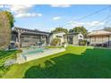 A backyard oasis with a pergola covered seating area and a private pool at 4627 E Montecito Ave, Phoenix, AZ 85018