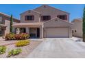 Inviting two-story home with a two-car garage and low-maintenance desert landscaping at 5445 S 239Th Dr, Buckeye, AZ 85326