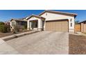 Inviting single-Gathering home featuring desert landscaping, neutral tones, and a two-car garage at 7442 W Redbird Rd, Peoria, AZ 85383