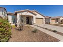 Beautiful single-Gathering home featuring a desert-friendly landscaped front yard and a two-car garage at 7442 W Redbird Rd, Peoria, AZ 85383