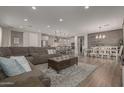 Spacious open-concept living area with hardwood floors and a seamless flow to the kitchen and dining area at 7442 W Redbird Rd, Peoria, AZ 85383