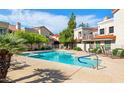 Community swimming pool surrounded by lounge chairs and verdant trees, perfect for relaxation at 7800 E Lincoln Dr # 1104, Scottsdale, AZ 85250