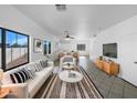 Bright living room area with modern decor, tile floors, and large windows to let in natural light at 837 E Minton St, Phoenix, AZ 85042