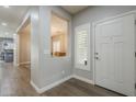 Bright entryway with hardwood floors and views into the dining area at 10249 E Kinetic Dr, Mesa, AZ 85212