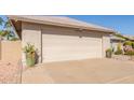 Home featuring a clean, two-car garage and desert landscaping at 10410 E San Tan Blvd, Sun Lakes, AZ 85248