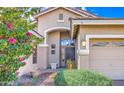 Inviting front entrance with a well-maintained lawn, desert landscaping, and a charming front door at 1086 S Western Skies Dr, Gilbert, AZ 85296