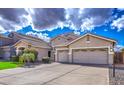 Spacious three-car garage and driveway of a charming single Gathering home in a suburban neighborhood at 1086 S Western Skies Dr, Gilbert, AZ 85296