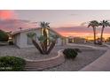 Charming single-story home with gravel landscaping, unique desert plants, and a lush green bush at 11005 W Crestbrook Dr, Sun City, AZ 85351