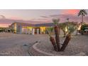 Charming single-story home with desert landscaping, mature desert plants, and a lengthy driveway at 11005 W Crestbrook Dr, Sun City, AZ 85351