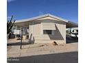 Charming manufactured home featuring an awning and xeriscaped front yard at 11411 N 91St Ave # 122, Peoria, AZ 85345