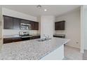 Beautiful kitchen with dark wood cabinets, stainless steel appliances, and a large island with granite countertops at 1344 W Kennedy Ave, Coolidge, AZ 85128