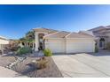 Charming single-Gathering home featuring a three-car garage and desert landscaping at 1363 E Amberwood Dr, Phoenix, AZ 85048