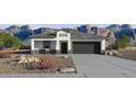 Charming single-story home with desert landscaping and a two-car garage against a mountain backdrop at 1404 W Kennedy Ave, Coolidge, AZ 85128