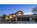 Beautiful two-story house showcasing its well-manicured front yard and elegant architectural details at twilight at 14052 S 24Th Way, Phoenix, AZ 85048