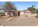 Single-story home featuring low-maintenance landscaping, two-car garage, and tile roof at 14410 N Silverado Dr, Fountain Hills, AZ 85268