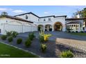 Stately home showcases a well-maintained lawn, mature landscaping, and a spacious driveway leading to a three-car garage at 1523 E Treasure Cove Dr, Gilbert, AZ 85234