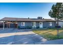 Inviting single-Gathering home with a manicured lawn, a cozy front porch bench, and ample parking at 1635 W Grovers Ave, Phoenix, AZ 85023