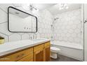 Bathroom featuring modern fixtures, sleek vanity, a contemporary mirror, and hexagon tile wall at 2117 W Pontiac Dr, Phoenix, AZ 85027