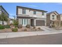 Attractive two-story home featuring a landscaped front yard and a two-car garage at 21186 W Hillcrest Blvd, Buckeye, AZ 85396