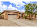 Charming single-story home with a neutral-toned exterior, low-maintenance desert landscaping, and a two-car garage at 2436 W Kachina Trl, Phoenix, AZ 85041