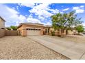 Lovely single-story home featuring desert landscaping, two-car garage, and a long driveway at 2436 W Kachina Trl, Phoenix, AZ 85041