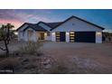 Stunning single-story home with modern garage doors and desert landscaping at 2438 N 113Th St, Mesa, AZ 85207