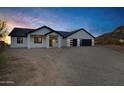 Inviting single-story home featuring a modern garage and desert surroundings at 2438 N 113Th St, Mesa, AZ 85207