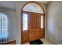 Detailed view of the front door featuring decorative glass, wood finish, and ornate hardware at 2542 S Playa --, Mesa, AZ 85202