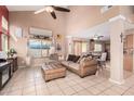 Cozy living room featuring tile flooring, a large window, and kitchen access at 25732 W St James Ave, Buckeye, AZ 85326