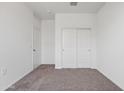 Neutral bedroom featuring plush carpet, white walls, and a closet with sliding doors at 28216 N Nealite Dr, San Tan Valley, AZ 85143