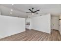 Bright living room features wood-look floors and a modern ceiling fan at 3026 W Ross Ave, Phoenix, AZ 85027