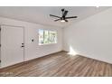 Cozy living room featuring wood-look floors and a view to the front yard at 3026 W Ross Ave, Phoenix, AZ 85027