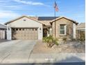 Charming home featuring a stone facade, neutral stucco, desert landscaping, and a two car garage at 303 S 197Th Ave, Buckeye, AZ 85326