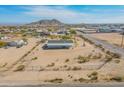 Expansive aerial view of a desert home featuring a vast lot and mountain backdrop at 31555 N Royce Rd, San Tan Valley, AZ 85144