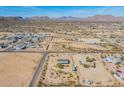 Wide aerial shot of a desert community showcasing the beautiful mountain range in the distance at 31555 N Royce Rd, San Tan Valley, AZ 85144