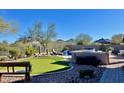 Manicured backyard with putting green, built-in BBQ, and mountain views provides an oasis at 31709 N 16Th Ave, Phoenix, AZ 85085