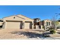 Stunning home with desert landscaping, a three-car garage, and stone accents at 31709 N 16Th Ave, Phoenix, AZ 85085