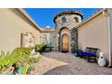 Charming courtyard entrance with stone tower, fountain, and lush greenery creates curb appeal at 31709 N 16Th Ave, Phoenix, AZ 85085