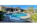 Beautiful backyard pool with seating area and outdoor kitchen, perfect for entertaining guests at 31709 N 16Th Ave, Phoenix, AZ 85085