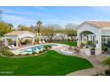 Resort-style backyard with pool, outdoor kitchen, built-in grill, and covered patios, perfect for entertaining at 3246 E San Miguel Pl, Paradise Valley, AZ 85253