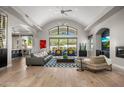 Open concept living room featuring vaulted ceilings, large windows, and stylish furnishings at 3246 E San Miguel Pl, Paradise Valley, AZ 85253